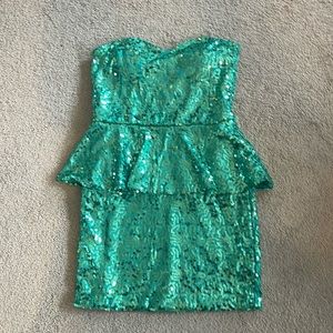 Green sequined peplum mini strapless dress